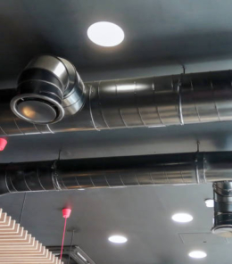 The ventilation duct is black on the ceiling in the room.