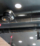The ventilation duct is black on the ceiling in the room.
