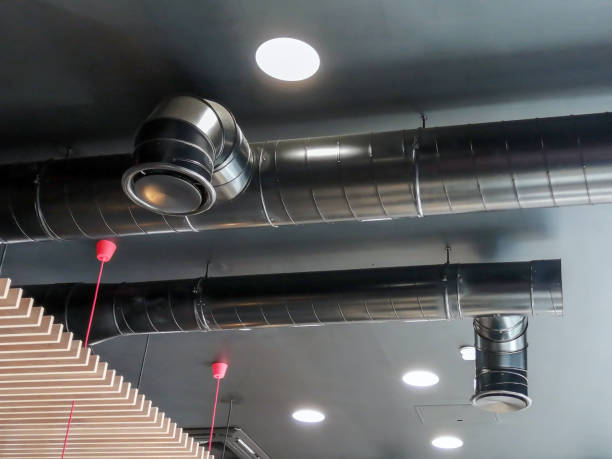 The ventilation duct is black on the ceiling in the room.