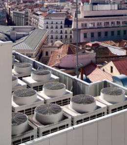 Industrial air conditioning and ventilation systems on the roof of a building on a sunny day.